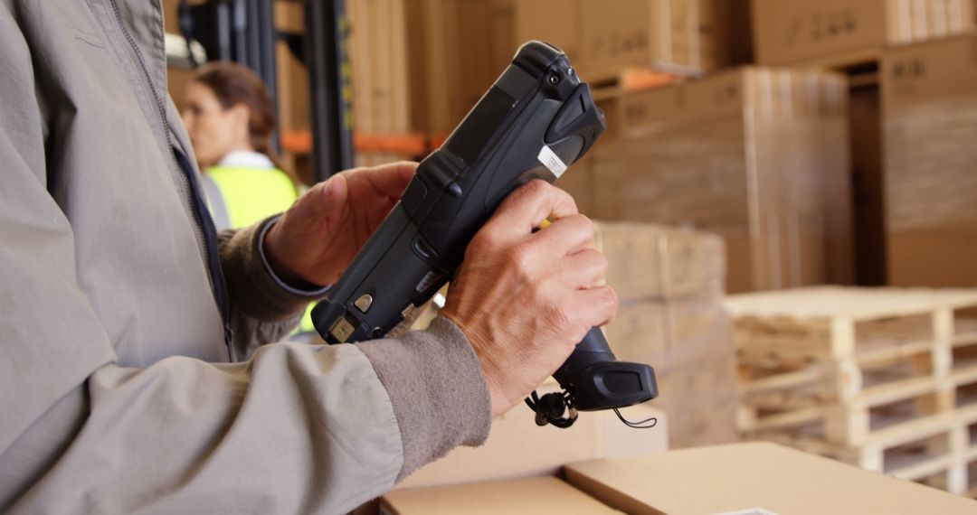 Warehouse Worker Scanning Packages with Handheld Device - Free Images, Stock Photos and Pictures on Pikwizard.com