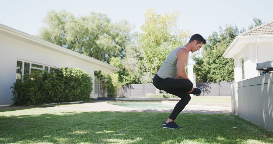 Man Exercising with Squats in Backyard on a Sunny Day - Free Images, Stock Photos and Pictures on Pikwizard.com