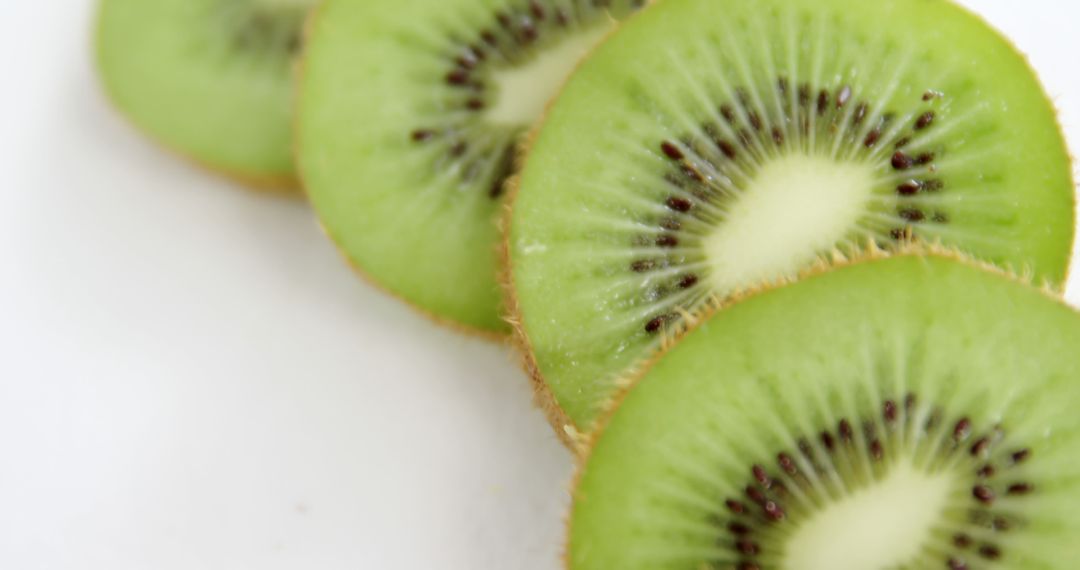 Close-Up of Fresh Kiwi Fruit Slices on White Background - Free Images, Stock Photos and Pictures on Pikwizard.com
