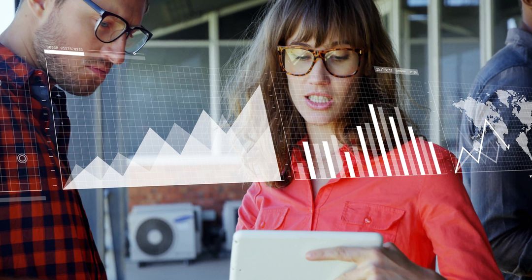 Business Professionals Analyzing Data on Digital Tablet with Overlapping Graphs