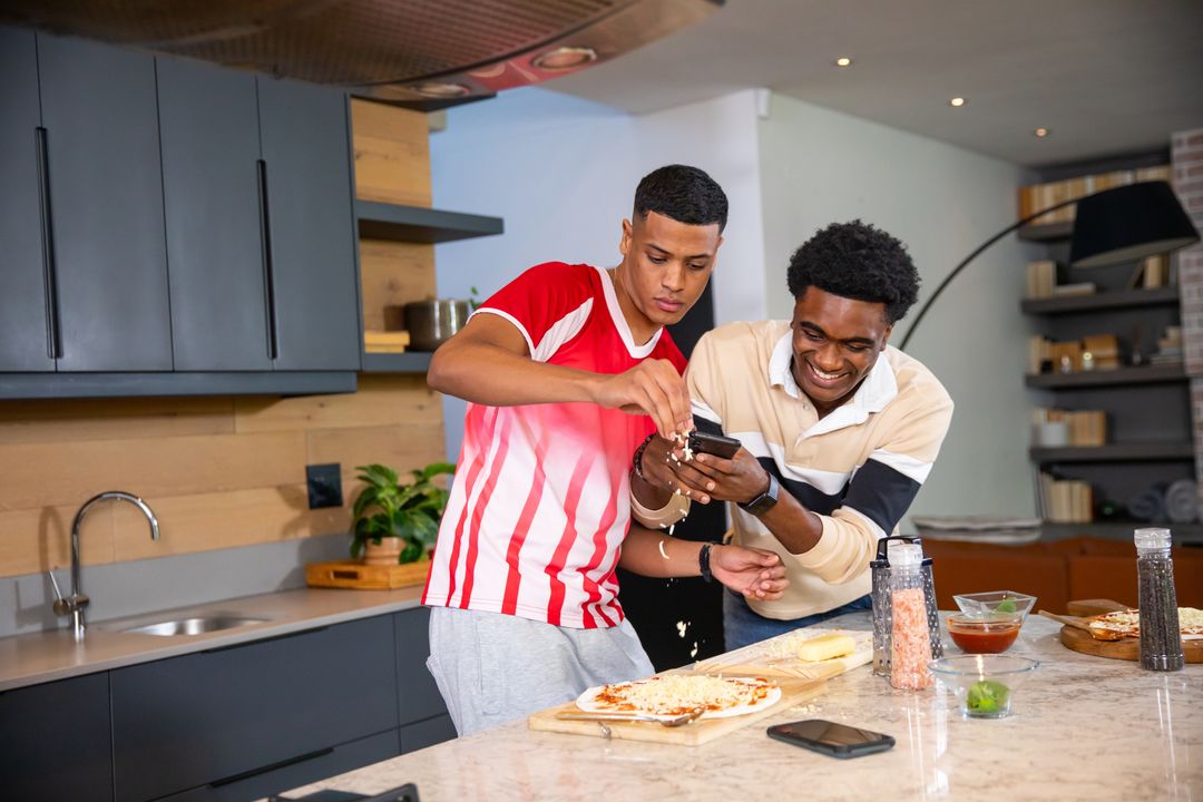 Diverse Friends Making Pizza and Laughing in Modern Kitchen