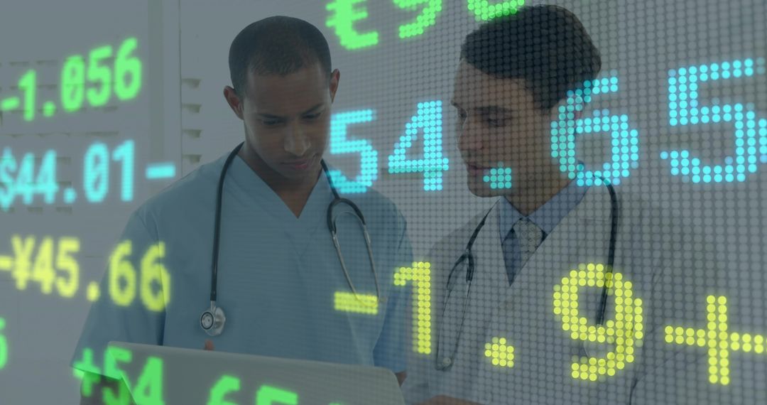 Medical Team Analyzing Healthcare Analytics and Financial Data on Laptop with Digital Overlay