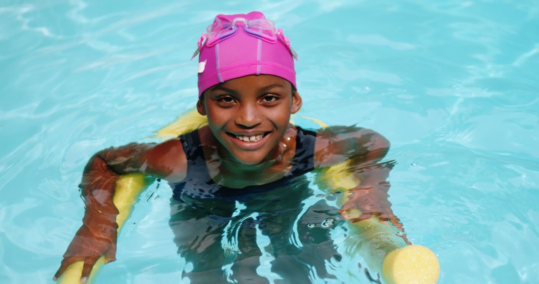 Smiling Girl Enjoying Pool with Pink Swim Cap and Noodle Float