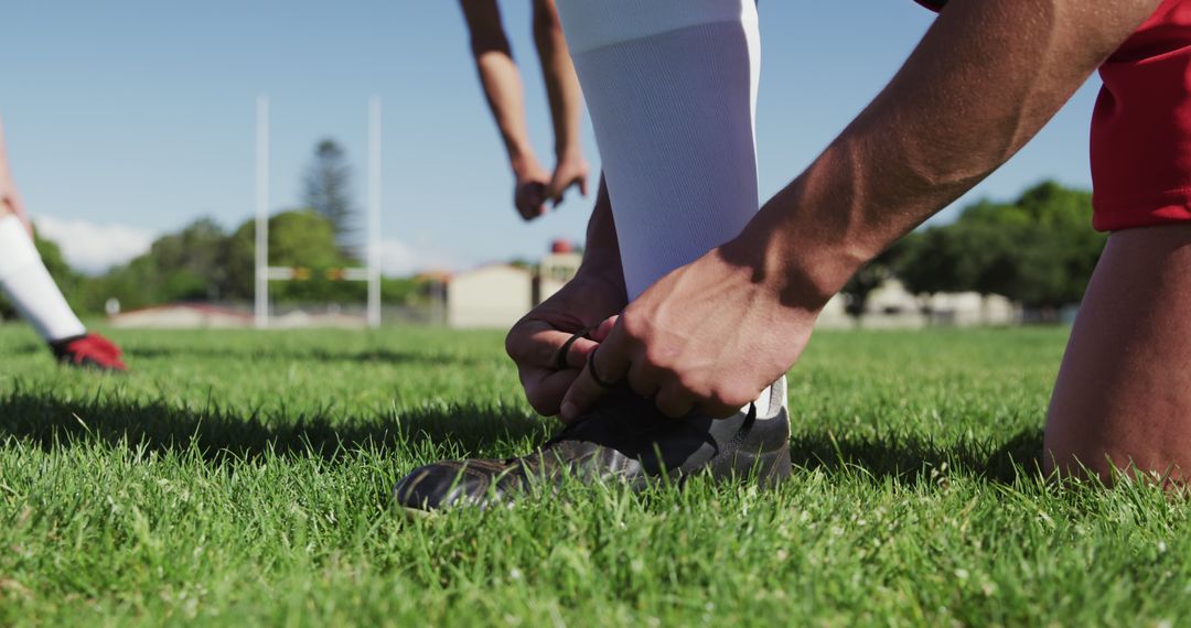 Athletic Man Tying Soccer Shoe on Field Before Game - Free Images, Stock Photos and Pictures on Pikwizard.com