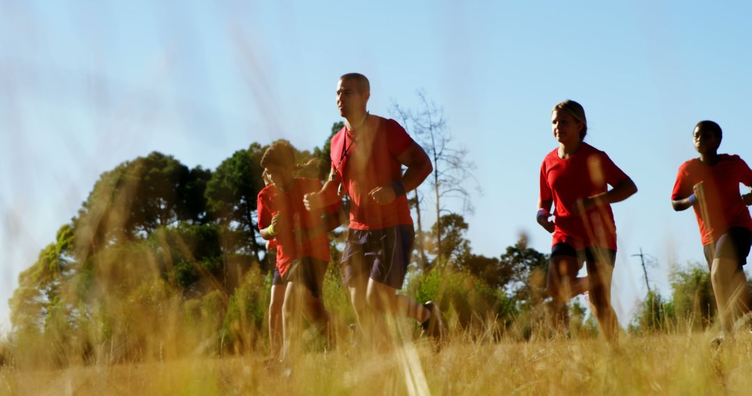 Group of People Running Through a Field in a Sunny Summer Day - Free Images, Stock Photos and Pictures on Pikwizard.com