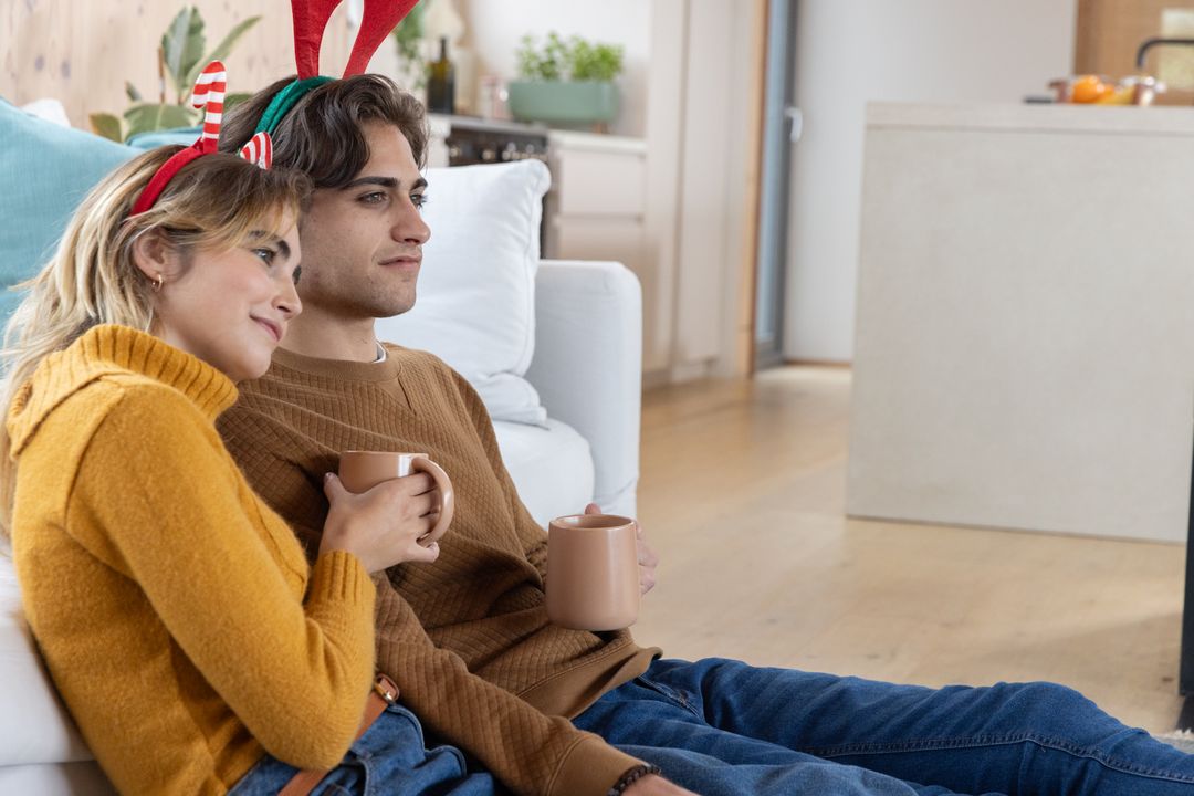 Couple Enjoys Warmth and Festivity with Hot Beverages and Holiday Spirit