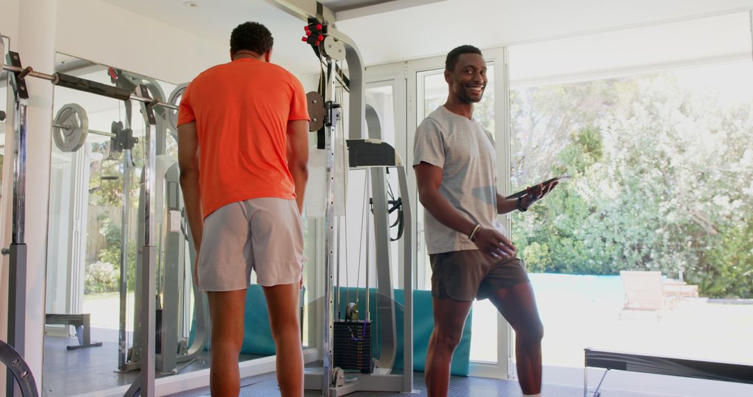 Trainer Guiding Client in Modern Gym Setting
