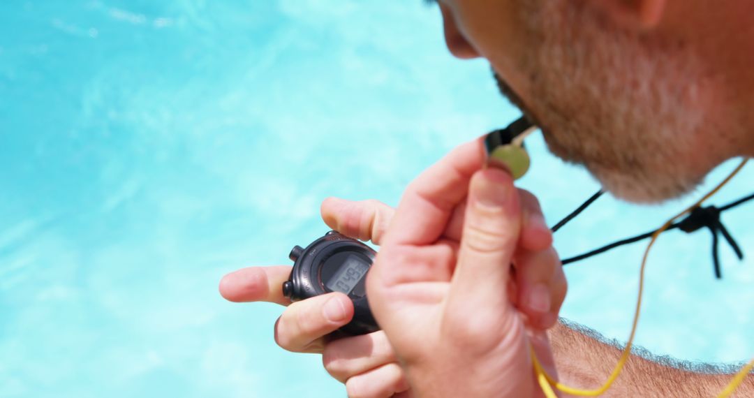 Close-Up of Swim Coach Timing at Poolside with Stopwatch - Free Images, Stock Photos and Pictures on Pikwizard.com