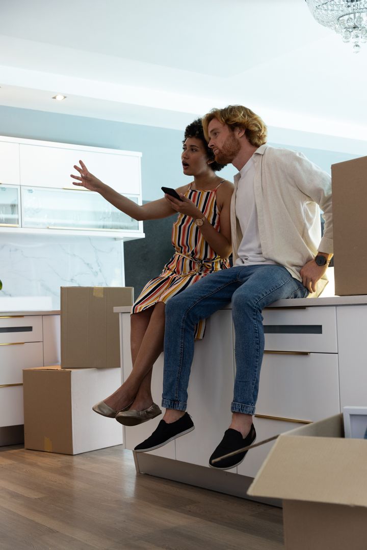 Diverse Couple Planning New Home with Moving Boxes