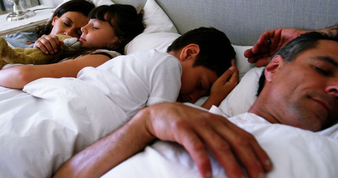 Family Sleeping Peacefully in Large Bed - Free Images, Stock Photos and Pictures on Pikwizard.com