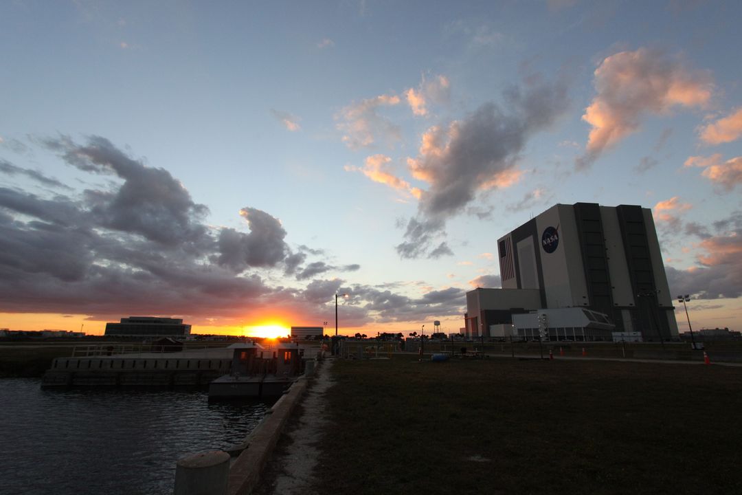 Sunset Over NASA's Kennedy Space Center with Vehicle Assembly Building - Free Images, Stock Photos and Pictures on Pikwizard.com