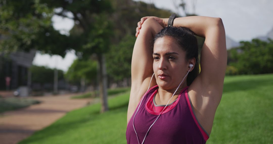 Woman Stretching Outdoors Before Exercise with Earphones - Free Images, Stock Photos and Pictures on Pikwizard.com