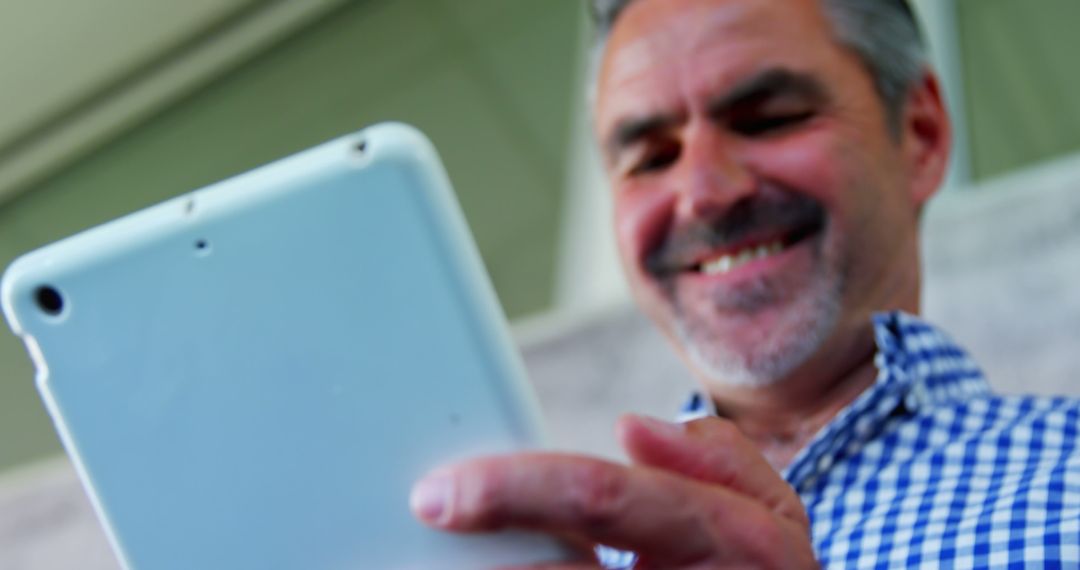 Senior Man Using Tablet, Smiling - Free Images, Stock Photos and Pictures on Pikwizard.com