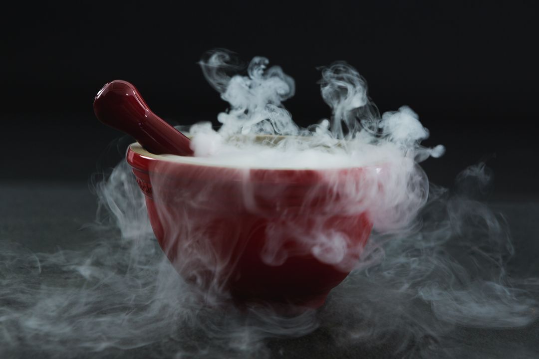 Dry ice smoke in bowl on black background - Free Images, Stock Photos and Pictures on Pikwizard.com