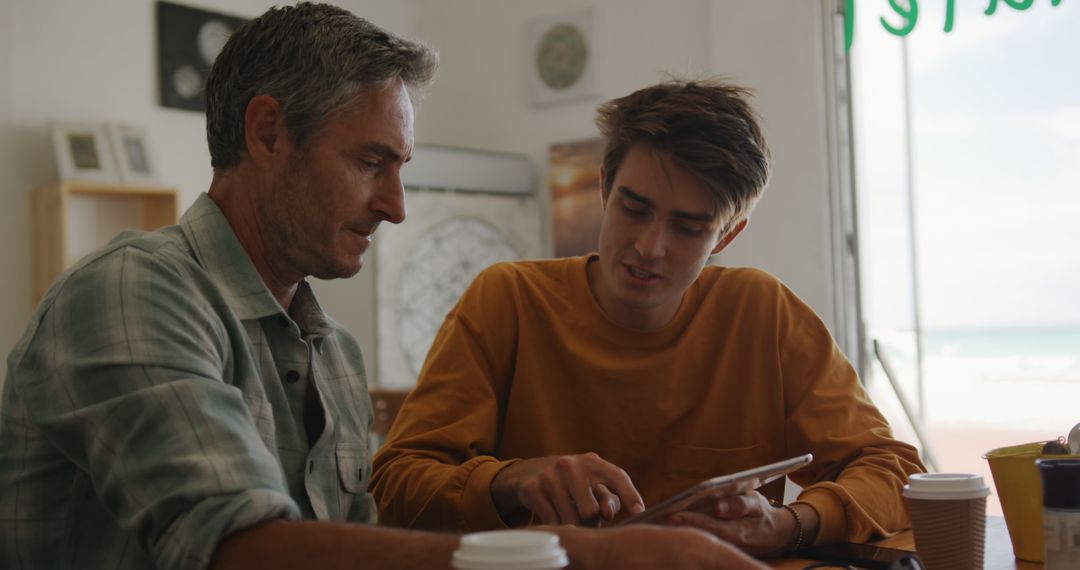 Father and Son Sharing Coffee Bonding in Cafe