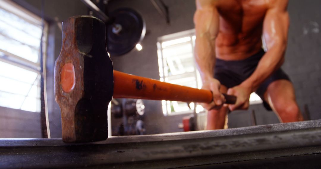 Muscular Man Swinging Sledgehammer in Intense Workout - Free Images, Stock Photos and Pictures on Pikwizard.com