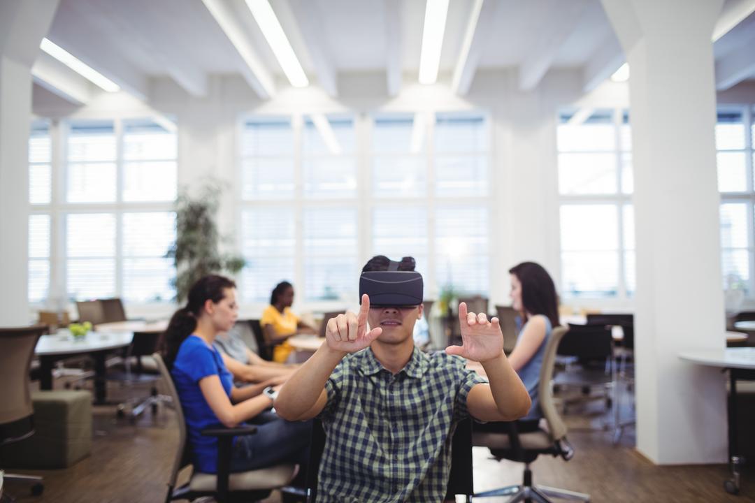Man Engaging with Virtual Reality in Modern Office - Free Images, Stock Photos and Pictures on Pikwizard.com