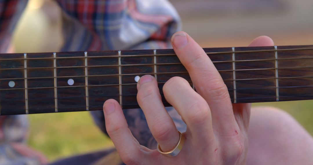 Close-Up Hand Playing Acoustic Guitar Outdoors - Free Images, Stock Photos and Pictures on Pikwizard.com