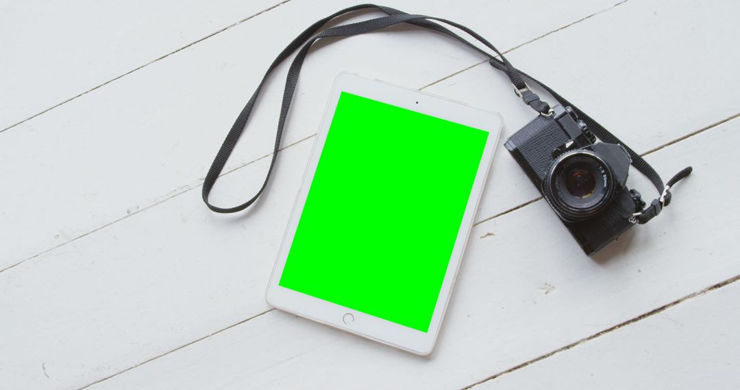 Digital Tablet and Camera on White Wooden Floor with Green Screen - Free Images, Stock Photos and Pictures on Pikwizard.com