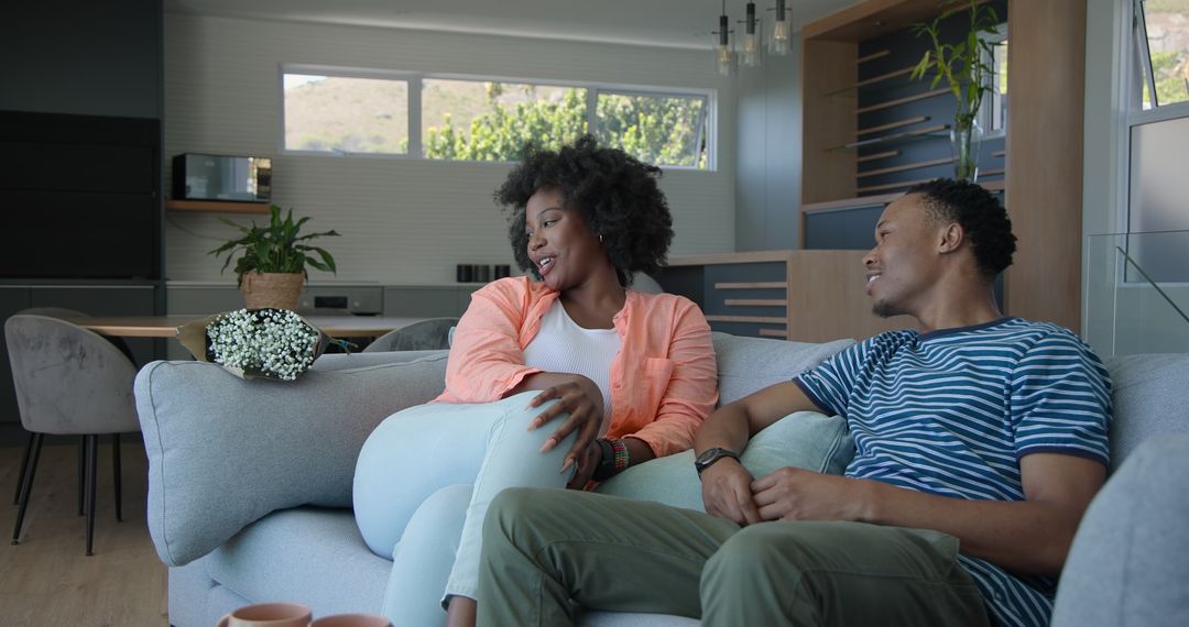 Young Couple Relaxing on Sofa and Enjoying Coffee Together at Home