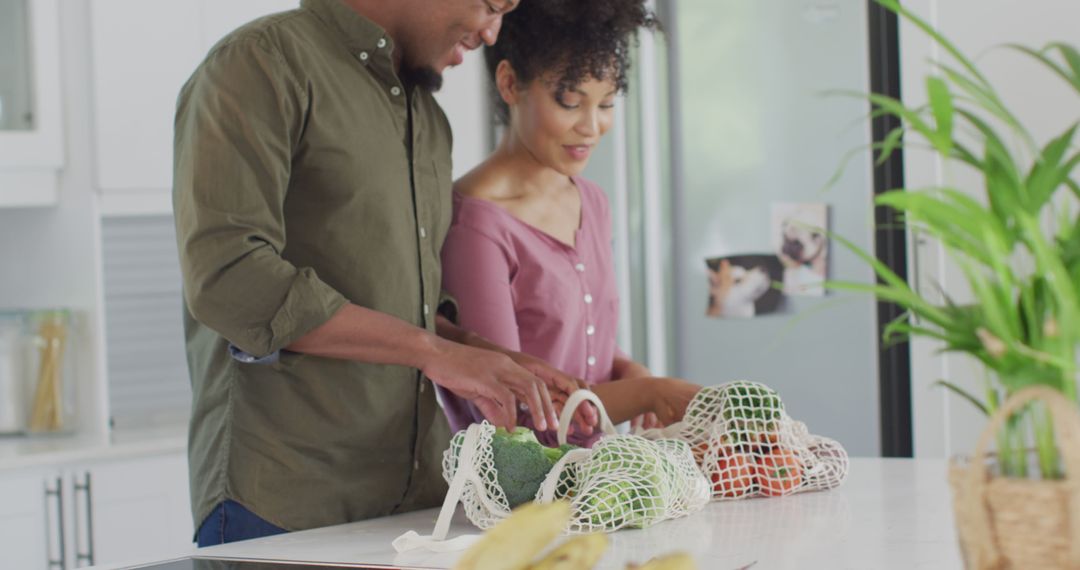 Happy Couple Unpacking Fresh Vegetables in Modern Kitchen - Free Images, Stock Photos and Pictures on Pikwizard.com