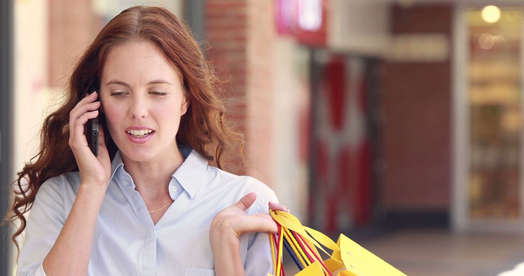 Woman Talking on Phone While Carrying Shopping Bags - Free Images, Stock Photos and Pictures on Pikwizard.com