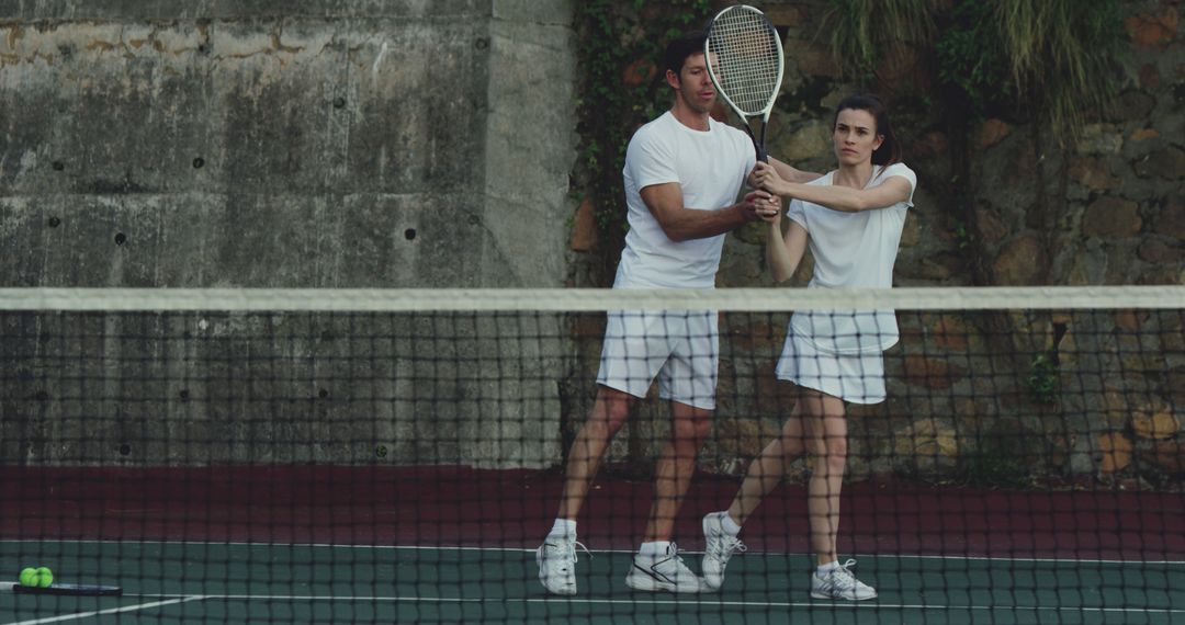 Tennis Instructor Teaching Young Woman Proper Grip Technique - Free Images, Stock Photos and Pictures on Pikwizard.com