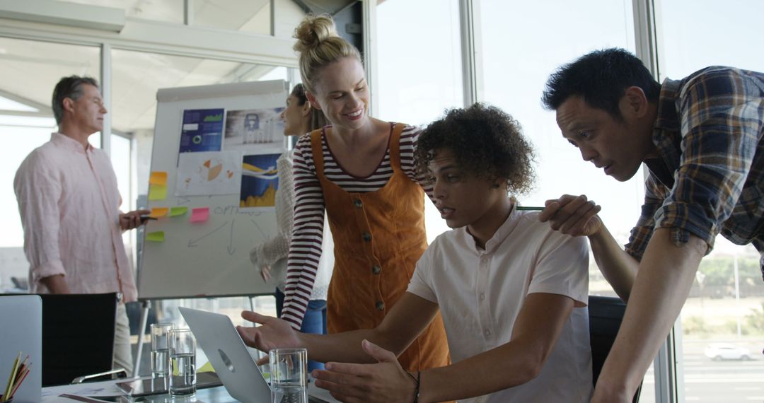 Team Collaboration in Modern Office with Laptop Discussion