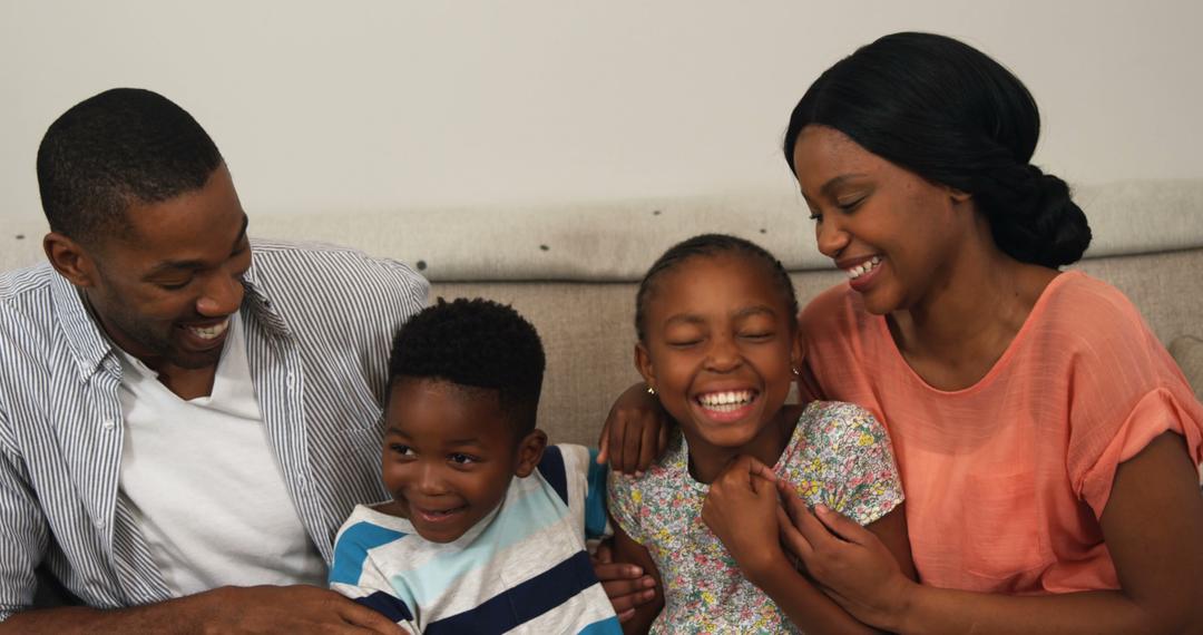 A happy African American family enjoys a playful moment together on the ...