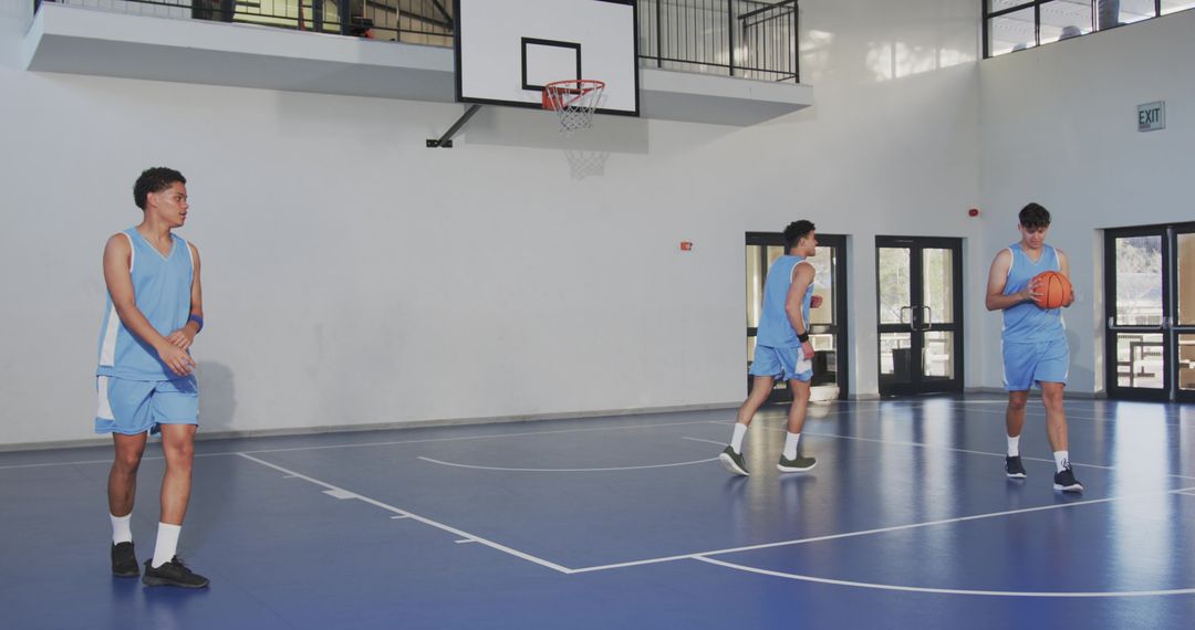 Young Athletes Practicing Basketball on Indoor Court