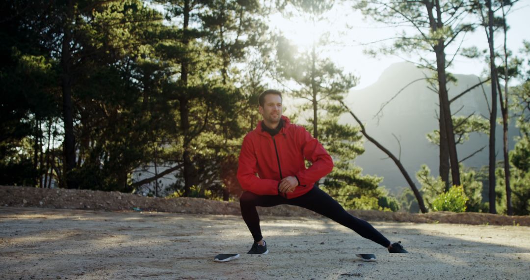 Man stretching legs outdoors in forest during sunrise workout - Free Images, Stock Photos and Pictures on Pikwizard.com