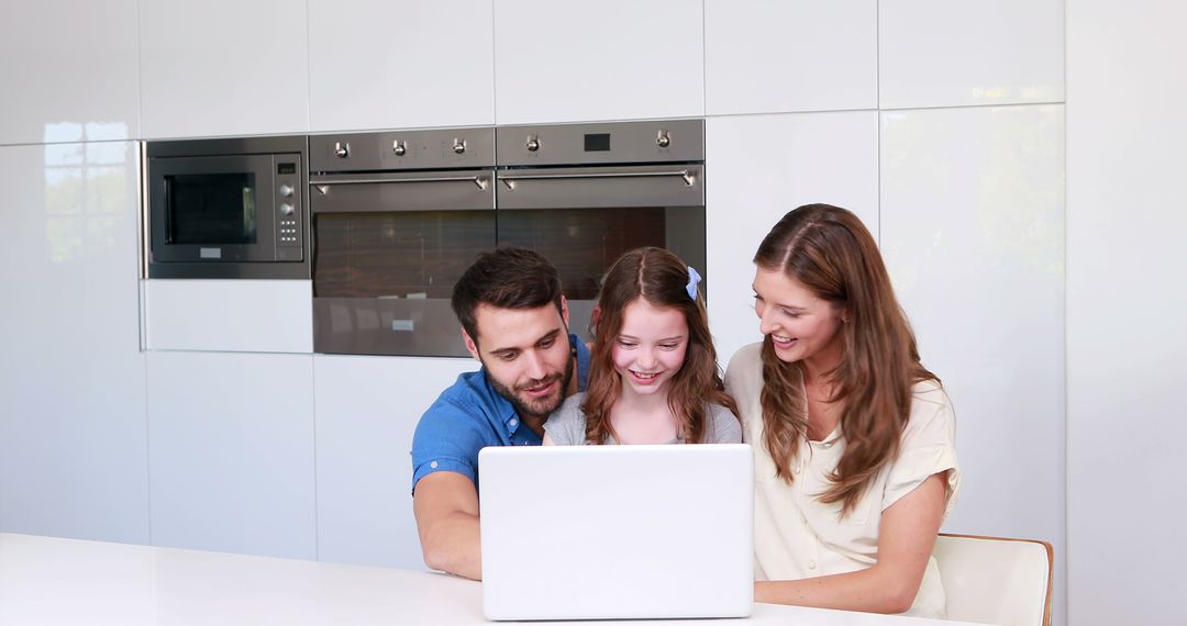 Happy Family Bonding Over Laptop in Modern Kitchen - Free Images, Stock Photos and Pictures on Pikwizard.com