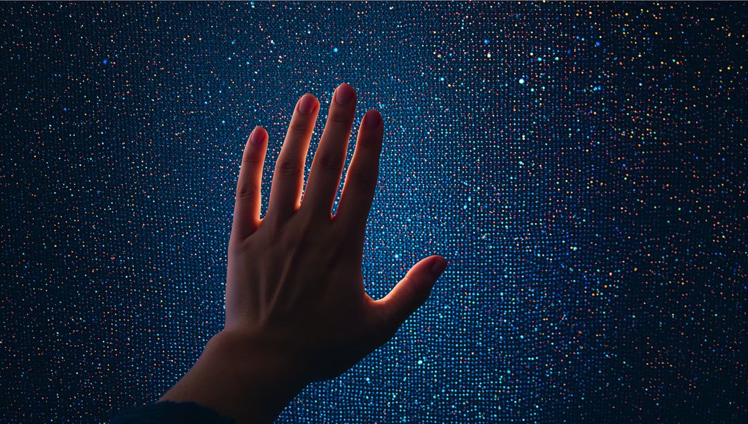Reaching Hand Touching Vibrant LED Pixel Grid with Blue Glow and Multicolor Sparkle