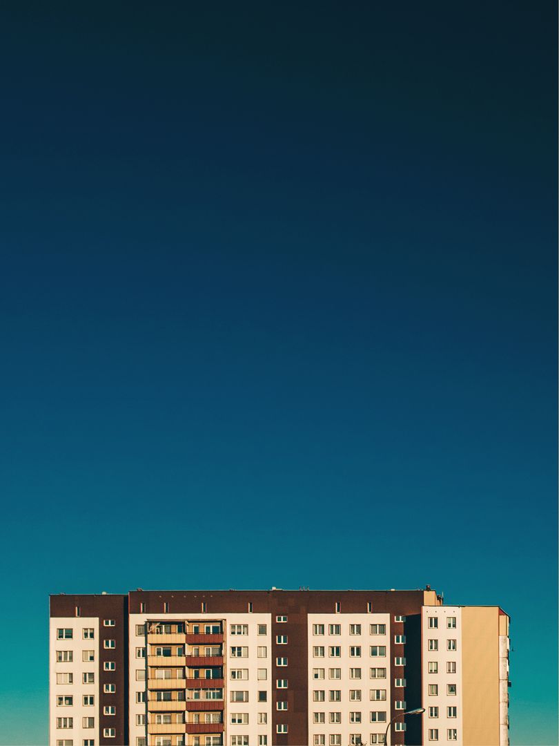 Apartment Building with Clear Blue Sky Background - Free Images, Stock Photos and Pictures on Pikwizard.com