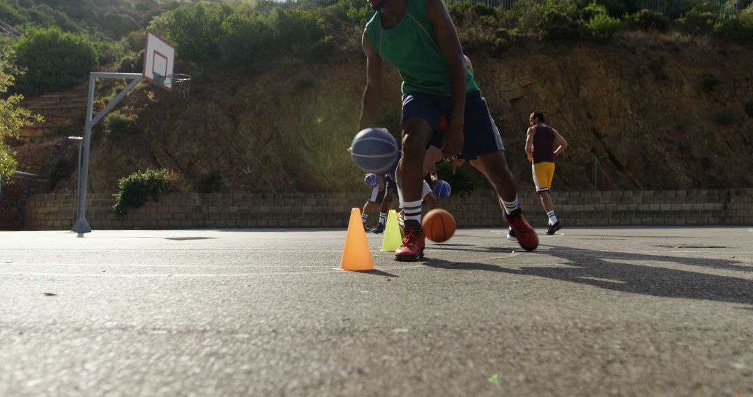 Young Athletes Dribbling Basketball on Outdoor Court During Training - Free Images, Stock Photos and Pictures on Pikwizard.com