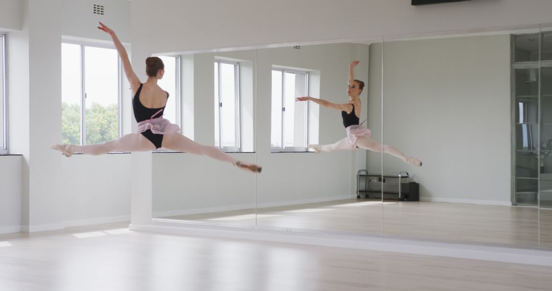 Caucasian Ballet Dancer Performing Elegant Split Jump in Studio