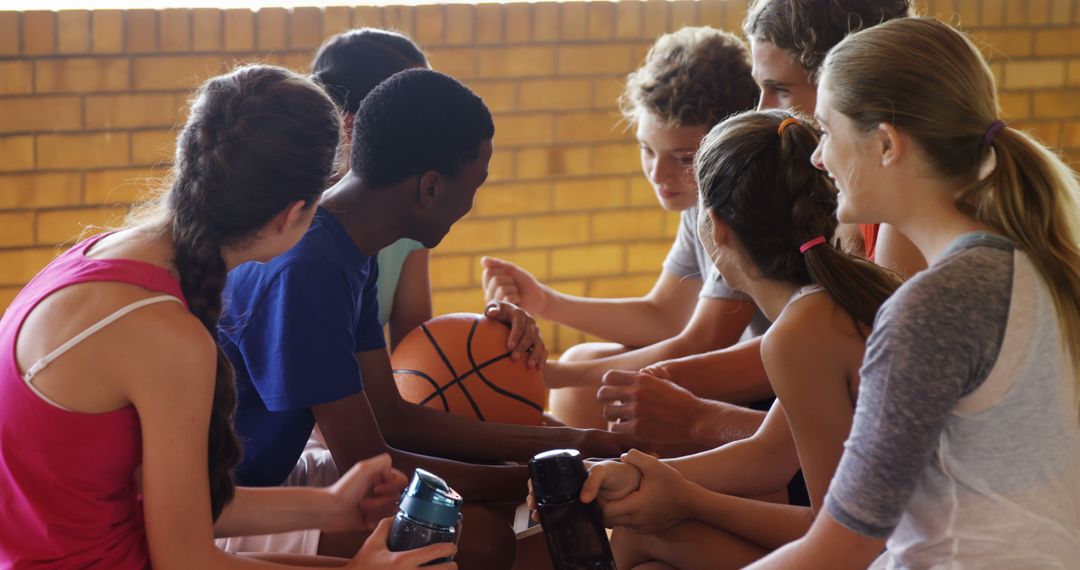 High School Teens Relaxing and Socializing in Gym With Basketball