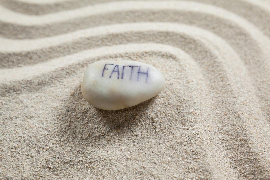 White Pebble with Faith Engraving on Sand - Free Images, Stock Photos and Pictures on Pikwizard.com