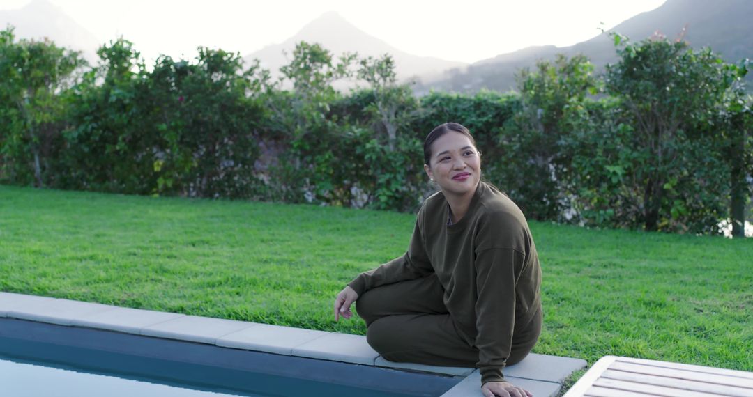 Woman Relaxing by Poolside with Scenic Mountain View