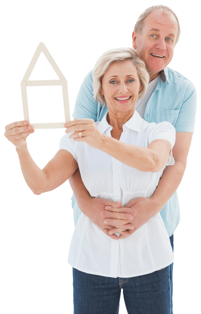 Smiling Senior Couple Holding Transparent House Frame