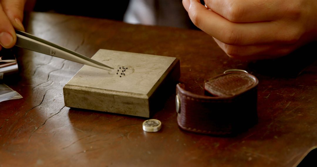 Jeweler Inspecting Diamonds with Tweezers at Workbench - Free Images, Stock Photos and Pictures on Pikwizard.com