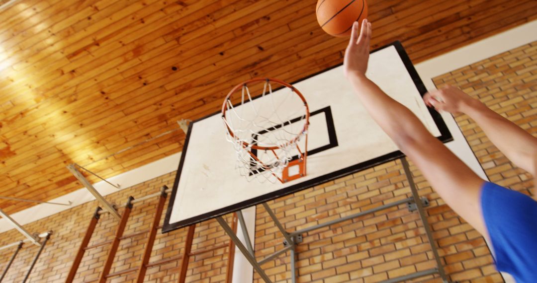 Basketball Player Aiming for Hoop Mid-Jump in School Gym - Free Images, Stock Photos and Pictures on Pikwizard.com