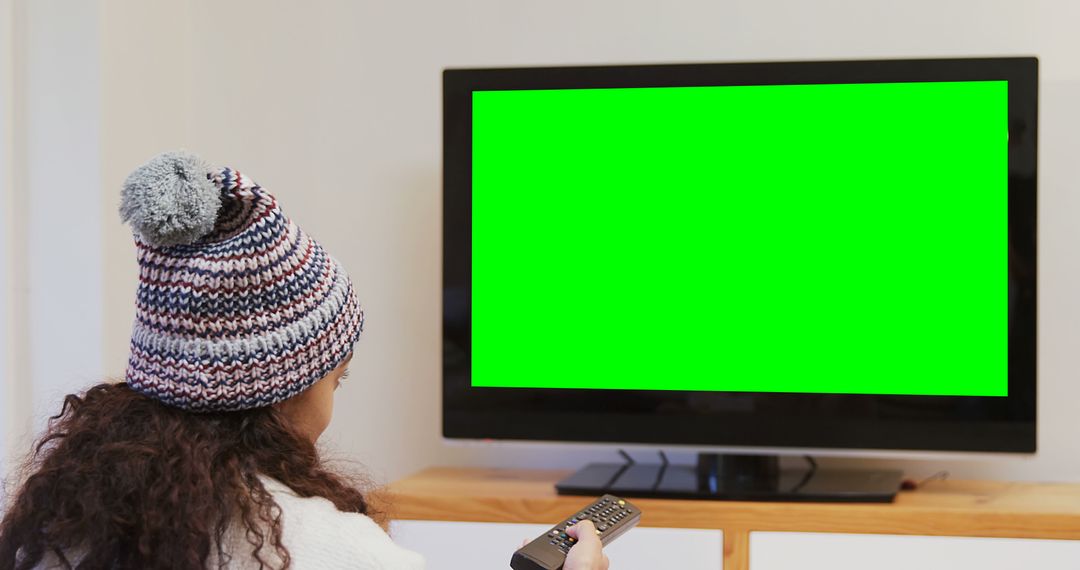 Person with Remote Control Watching TV with Green Screen - Free Images, Stock Photos and Pictures on Pikwizard.com