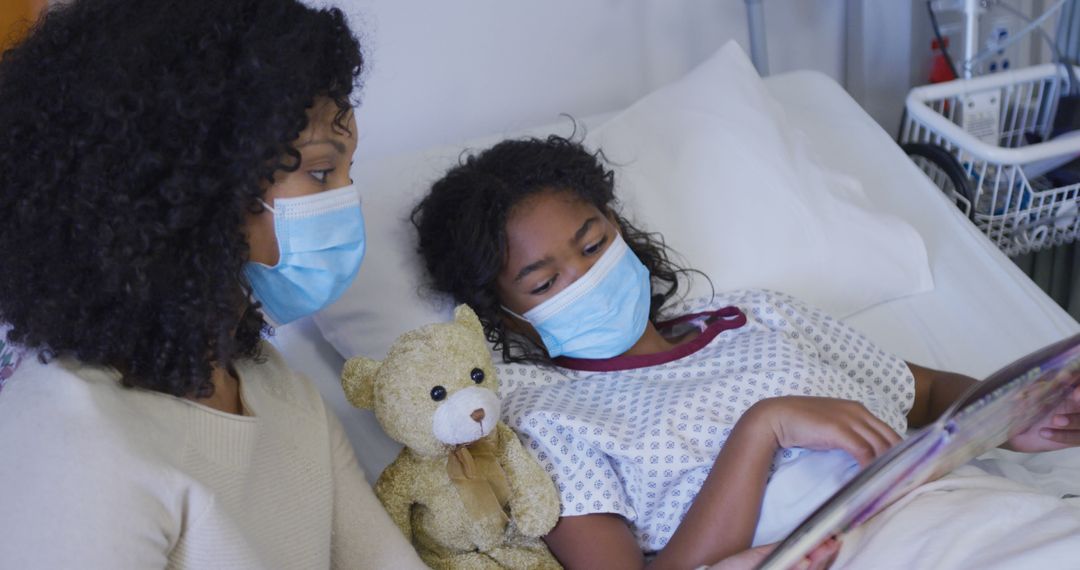 Child and Mother Wearing Masks in Hospital Bed with Teddy Bear - Free Images, Stock Photos and Pictures on Pikwizard.com