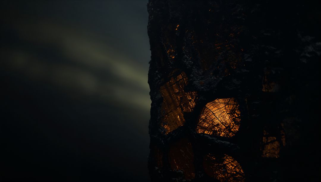 Glowing Ember Streaks on Charred Tree Bark in Dark Forest