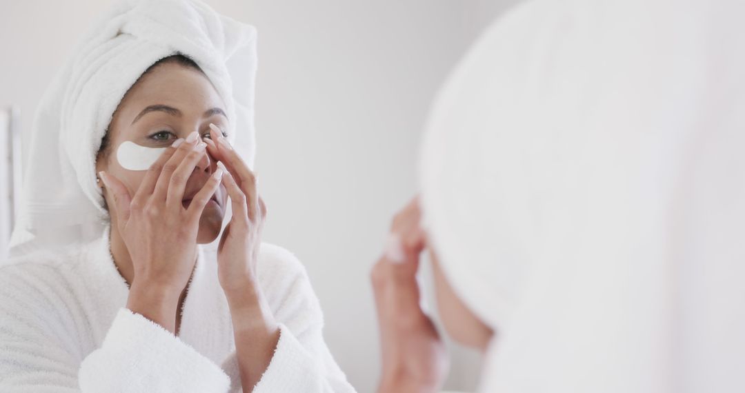 Woman Applying Under-Eye Patches in Bathroom for Skin Care - Free Images, Stock Photos and Pictures on Pikwizard.com