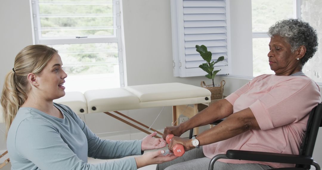 Physical Therapist Assisting Elderly Woman with Dumbbell Exercise - Free Images, Stock Photos and Pictures on Pikwizard.com