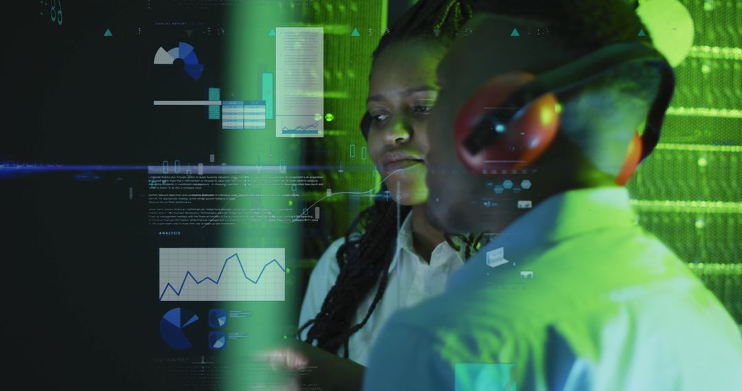 It engineers analyzing data visualization in server room