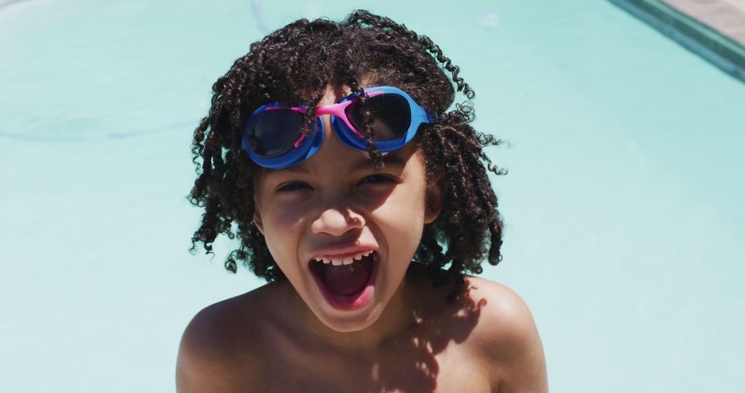 Portrait of happy biracial boy looking at camera in swimming pool - Free Images, Stock Photos and Pictures on Pikwizard.com