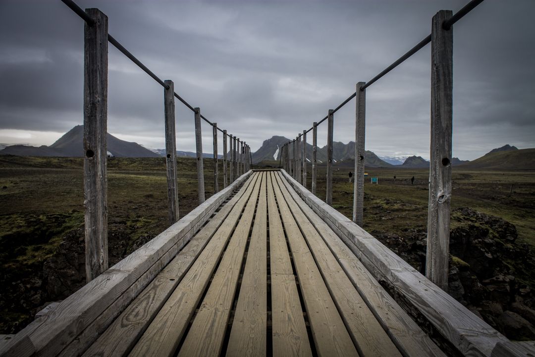 Suspension Bridge Over Rocky Terrain on Cloudy Day - Free Images, Stock Photos and Pictures on Pikwizard.com